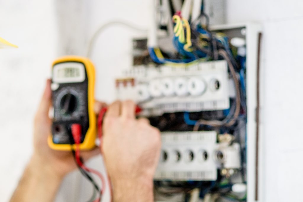 Generator franchise opportunities - Electrician testing for voltage in a fuse box